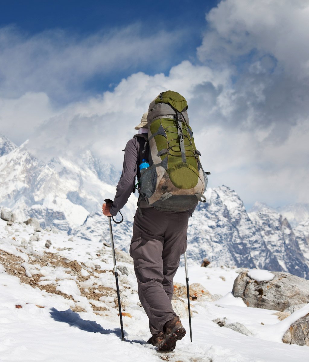 Hiker in layered clothing on a Himalayan trek